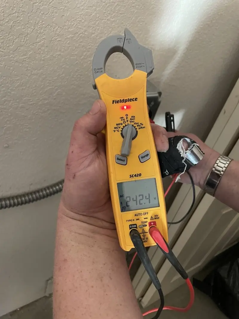 Voltage testing with clamp meter during Ceiling Fan Installation in Mango